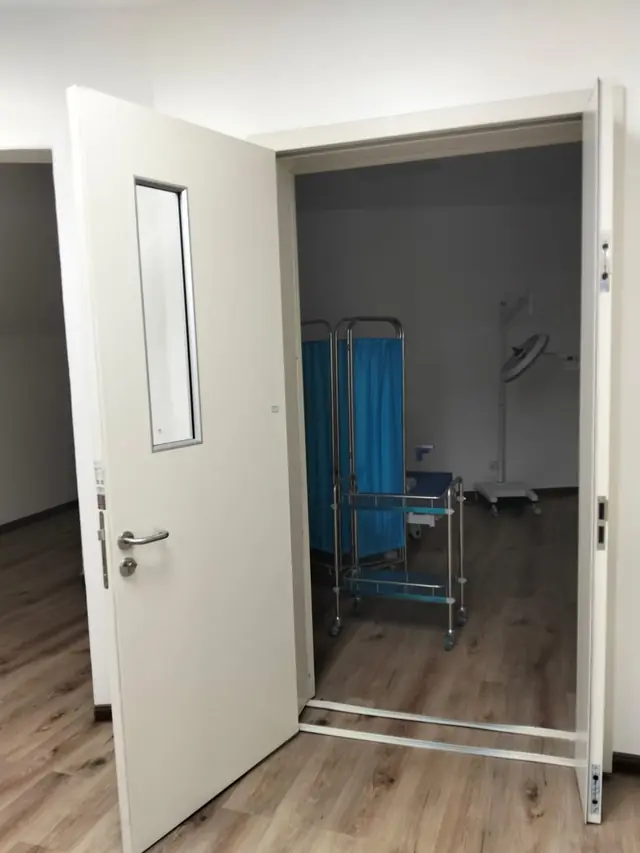 Door with narrow vision panel to a clinical room