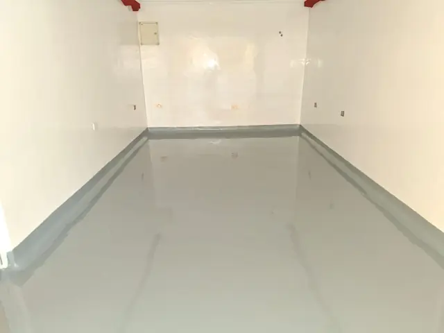 Grey epoxy floor with coved skirting
